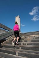 young  couple jogging on steps photo