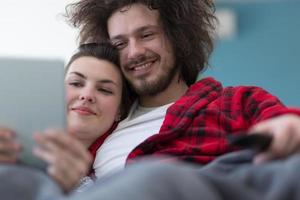 couple relaxing at  home with tablet computers photo