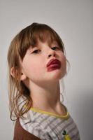 Little girl playing with mommy's make up photo