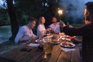 friends having picnic french dinner party outdoor during summer holiday photo