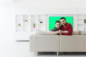 couple hugging and relaxing on sofa photo