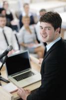 Young  business man giving a presentation on conference photo