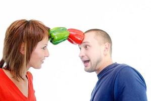 happy couple holding peppers with head photo