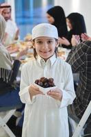 Arabian kid in the traditional clothes during iftar photo