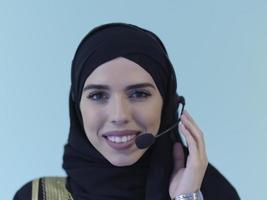 Portrait of young muslim woman with headphones photo