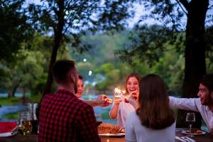 happy friends having french dinner party outdoor photo