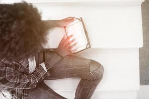 mujer negra usando su tableta electrónica foto