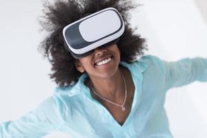 black girl using VR headset glasses of virtual reality photo