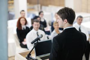 Young  business man giving a presentation on conference photo