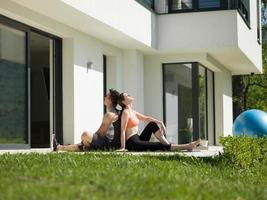 woman with personal trainer doing morning yoga exercises photo