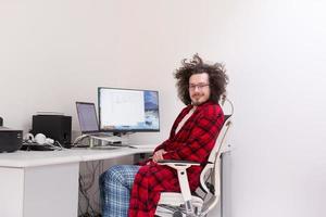 graphic designer in bathrobe working at home photo