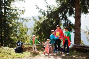 Mother with four kids resting in mountains. Family travel and hiking with childrens. photo