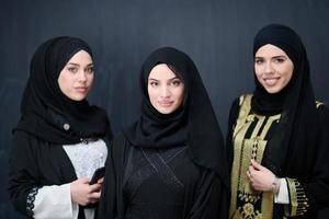 portrait of beautiful muslim women in fashionable dress photo