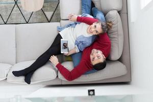 couple relaxing at  home with tablet computers photo