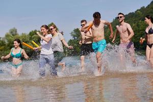 group of happy friends having fun on river photo