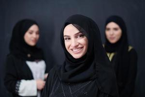 portrait of beautiful muslim women in fashionable dress photo