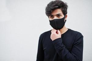 Asian man wear all black with face mask isolated on white background. photo