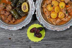 Eid Mubarak Traditional Ramadan Iftar dinner. Assorted tasty food in authentic rustic dishes on wooden table background. photo
