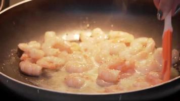 Fried shrimp in a pan. Shrimps, squids, seafood are fried over high heat. Horizontal video. Close-up. video