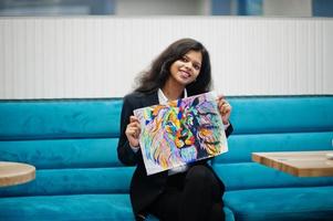 Indian artist woman wear formal paint picture, while sitting at cafe. photo