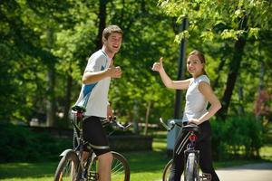 Happy couple riding bicycle outdoors photo