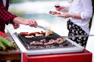 Man cooking tasty food on barbecue grill photo