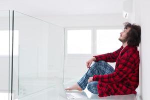 young freelancer in bathrobe working from home photo