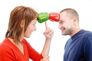 happy couple holding peppers with head photo