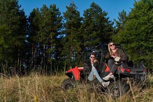 couple enjoying beautiful sunny day while driving a off road buggy photo