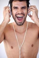 handsome young man listening music on headphones photo