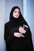 muslim business woman using tablet computer photo