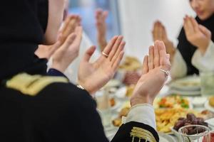 Muslim family making iftar dua to break fasting during Ramadan photo