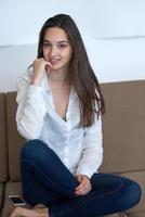 relaxed young woman at home working on laptop computer photo