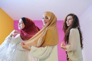 muslim women in fashionable dress isolated on pink photo