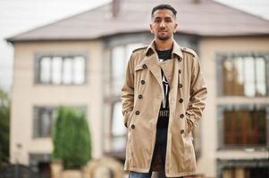 Stylish kuwaiti man at trench coat. photo