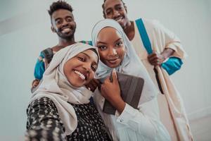 A group of multiethnic students take a selfie with a smartphone on a white background. Selective focus photo