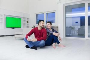 Young Couple using digital tablet on the floor photo