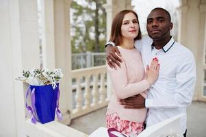 Happy multiethnic couple in love story. Relationships of african man and white european woman. photo