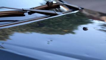 Damaged car engine hood with many hail damage dents show the importance of car insurance and a replacement value insurance against stormy weather storm hazards or extreme weather hail storms blizzards video