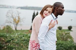 Happy multiethnic couple in love story. Relationships of african man and white european woman. photo