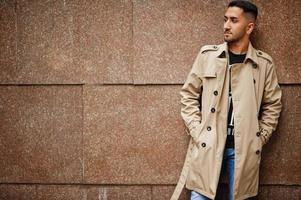 Stylish kuwaiti man at trench coat. photo