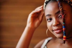 Close up porrtrait of lovely african american woman with dreadlocks in leopard outfit at cafe. Beautiful cool fashionable black young girl indoor. photo