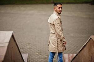 Stylish kuwaiti man at trench coat. photo