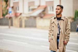 Stylish kuwaiti man at trench coat. photo