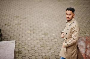 Stylish kuwaiti man at trench coat. photo