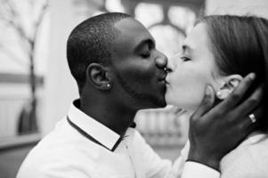 Happy multiethnic couple in love story. Relationships of african man and white european woman. photo