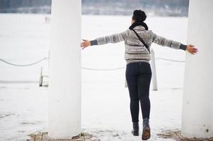 Back of african woman wear in black scarf pose in winter day at Europe. photo