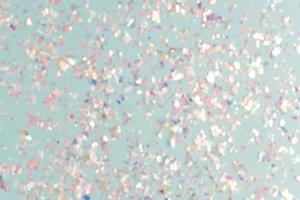 pearl confetti sparkles on blue holiday background. Festive backdrop or greeting card for designers. photo