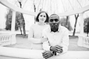 Happy multiethnic couple in love story. Relationships of african man and white european woman. photo