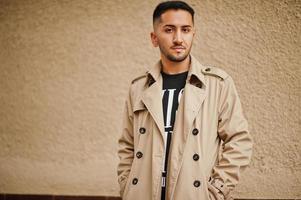 Stylish kuwaiti man at trench coat. photo